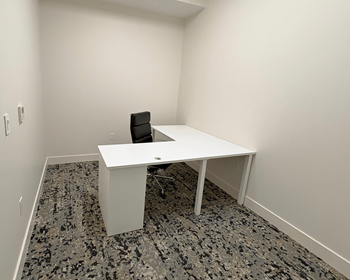 Private workspace at Sky on Main Apartments with a desk and chair for independent work in a quiet environment.