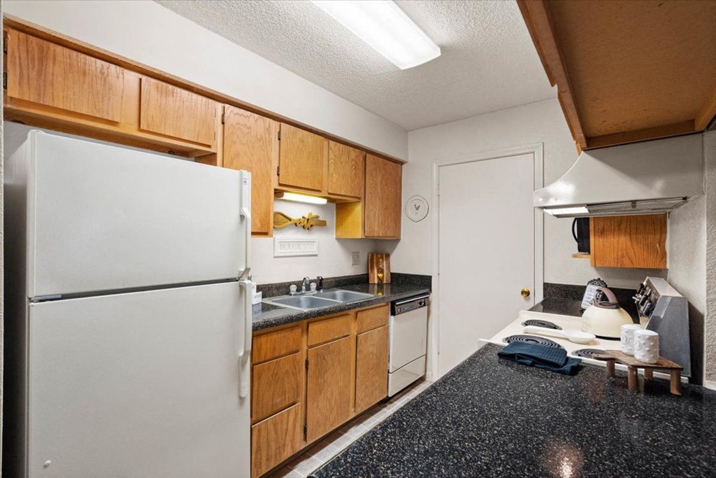 a kitchen with a refrigerator and a sink at Wind River Lodge, Kansas