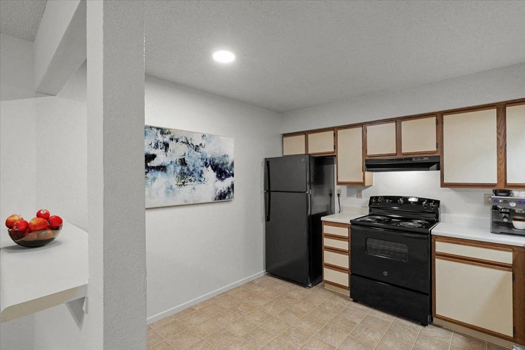 a kitchen with a stove and a refrigerator