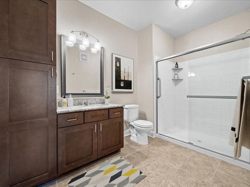 a bathroom with a toilet and a shower