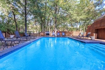 pool with trees  at Creekview Apartment Homes, Dallas, Texas