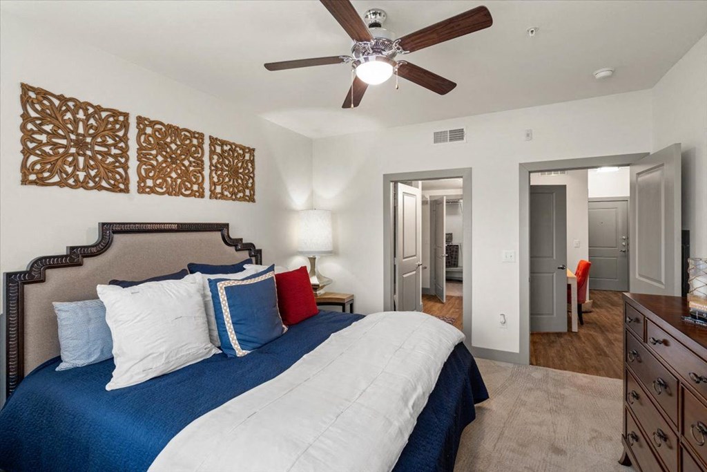 Bedroom with ceiling fan at Ovation at Lewisville Apartments, Texas , 75067