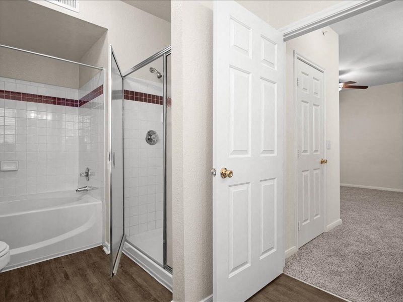 a white bathroom with a shower and a toilet