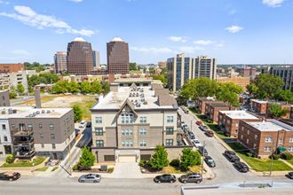 an aerial view of a large brick building in the middle of a city