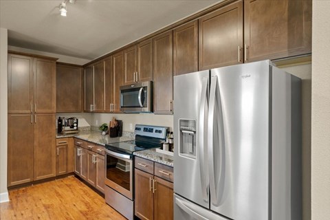 A kitchen with wooden cabinets and stainless steel appliances.