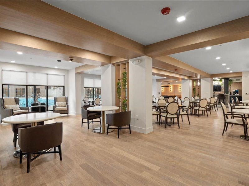 the lobby of a restaurant with tables and chairs