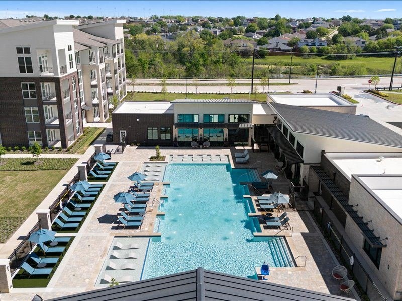 an aerial view of a swimming pool at an apartment building