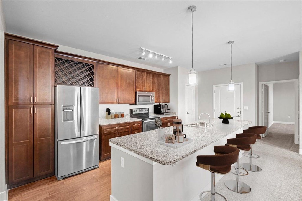 a kitchen with stainless steel appliances and a marble counter top