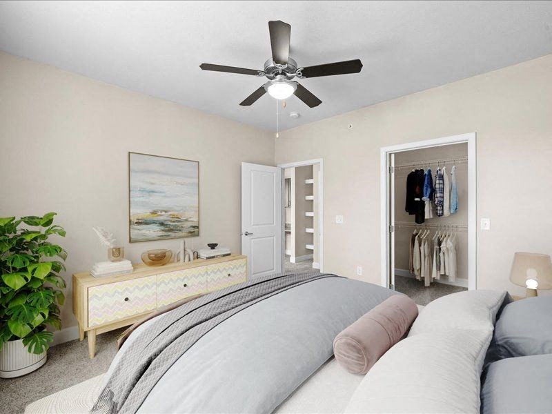 a bedroom with a bed and a ceiling fan