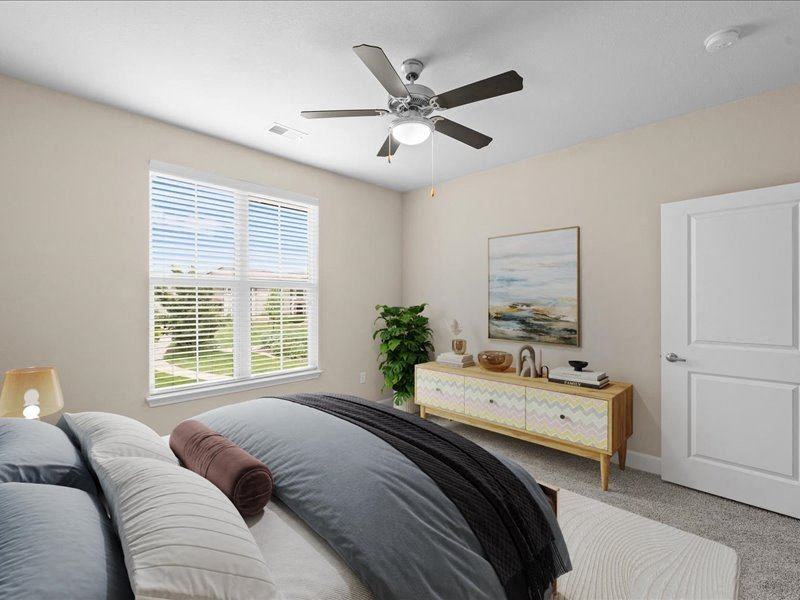 a bedroom with a bed and a ceiling fan