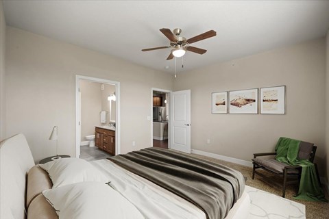 A bedroom with a large bed and a ceiling fan.
