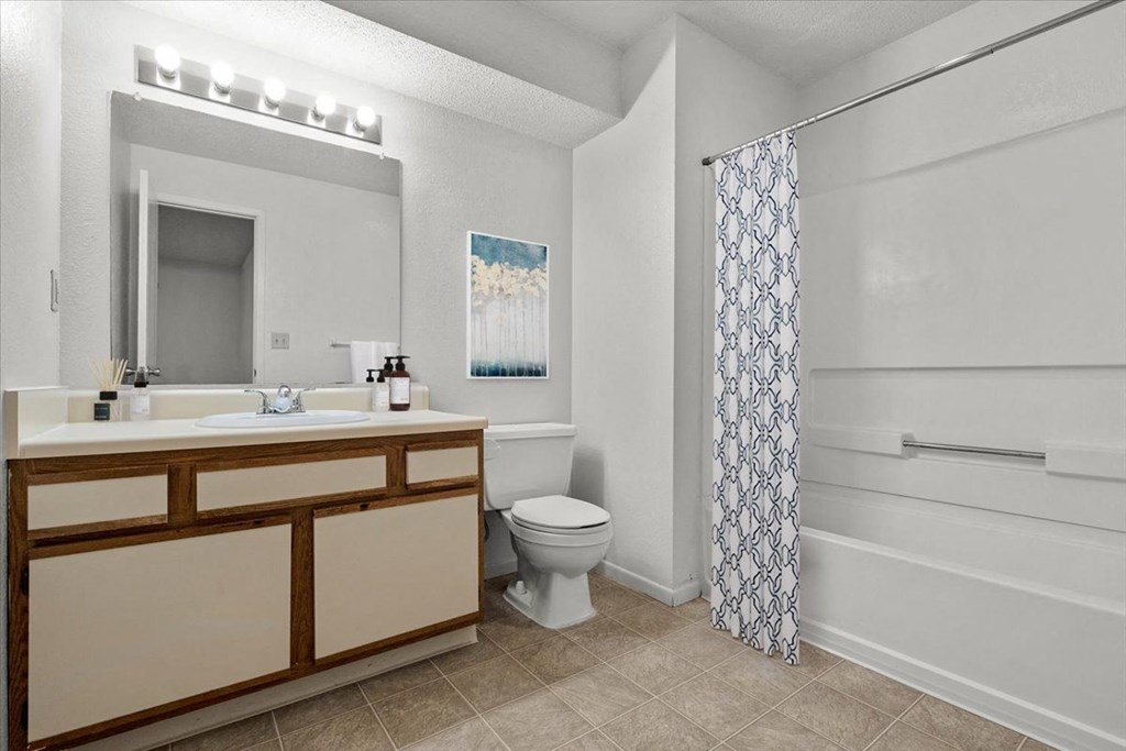 a bathroom with a toilet and a sink and a shower