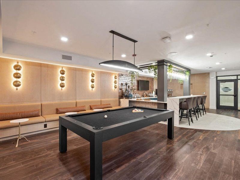 a restaurant with pink and purple lights and tables