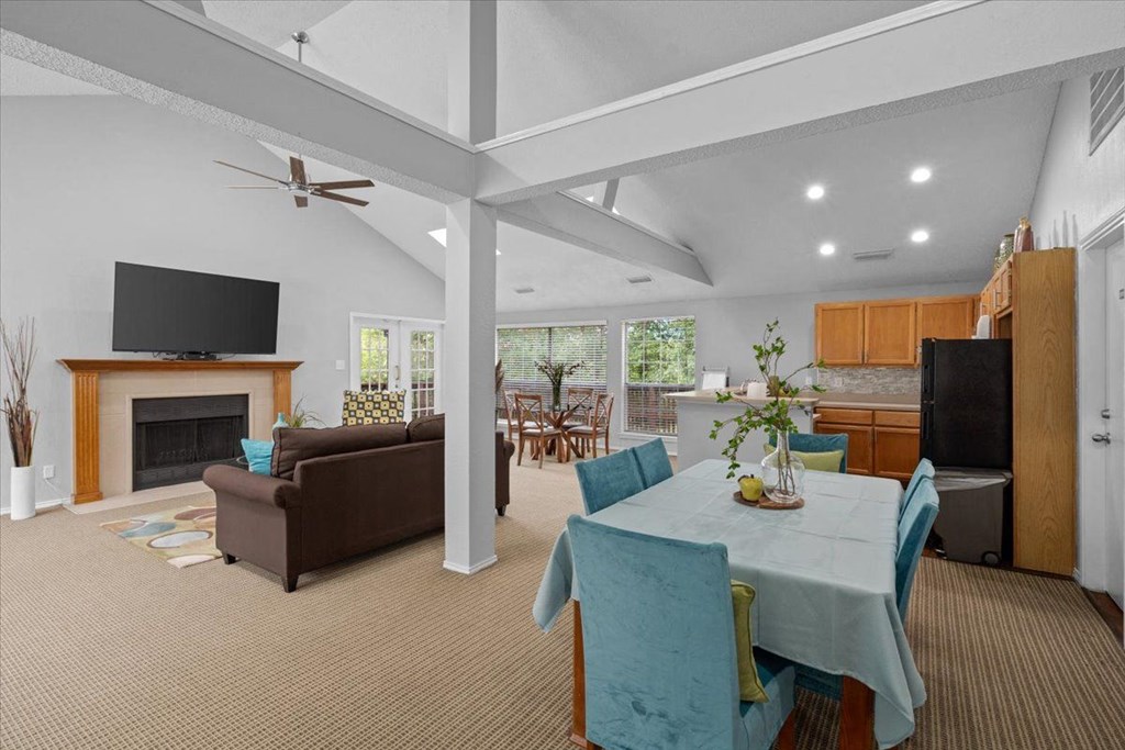 a living room with a table and chairs and a fireplace at Creekview Apartment Homes, Texas, 75254