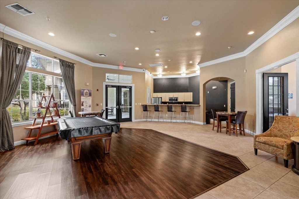 a game room with a foosball table and a bar