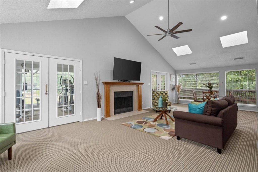 a living room with a fireplace and a tv above it at Creekview Apartment Homes, Dallas, Texas