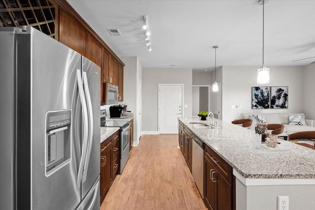 a kitchen with stainless steel appliances and granite counter tops