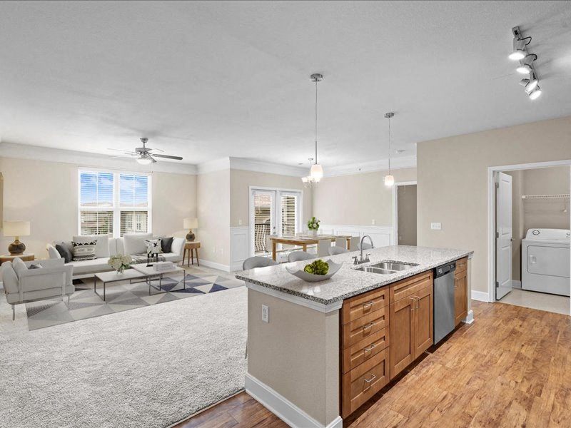 a kitchen with an island and a living room with a couch