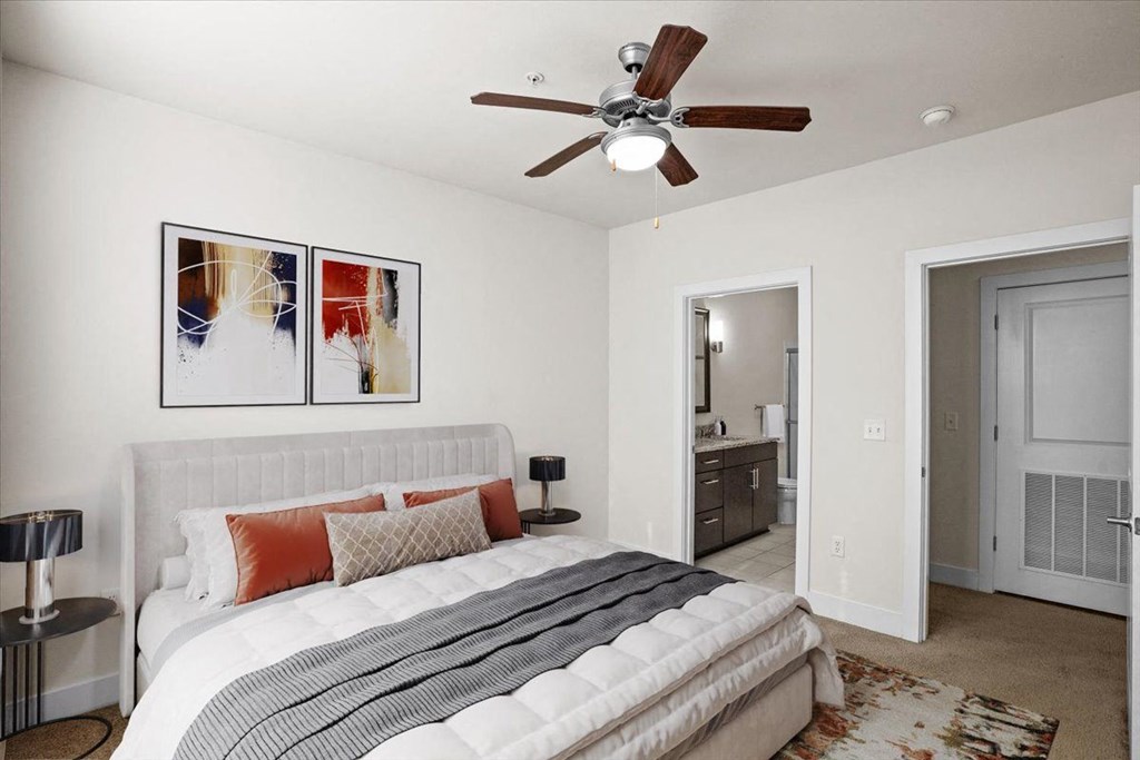 a bedroom with a bed and a ceiling fan