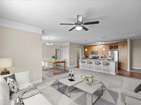 a living room and kitchen with a ceiling fan