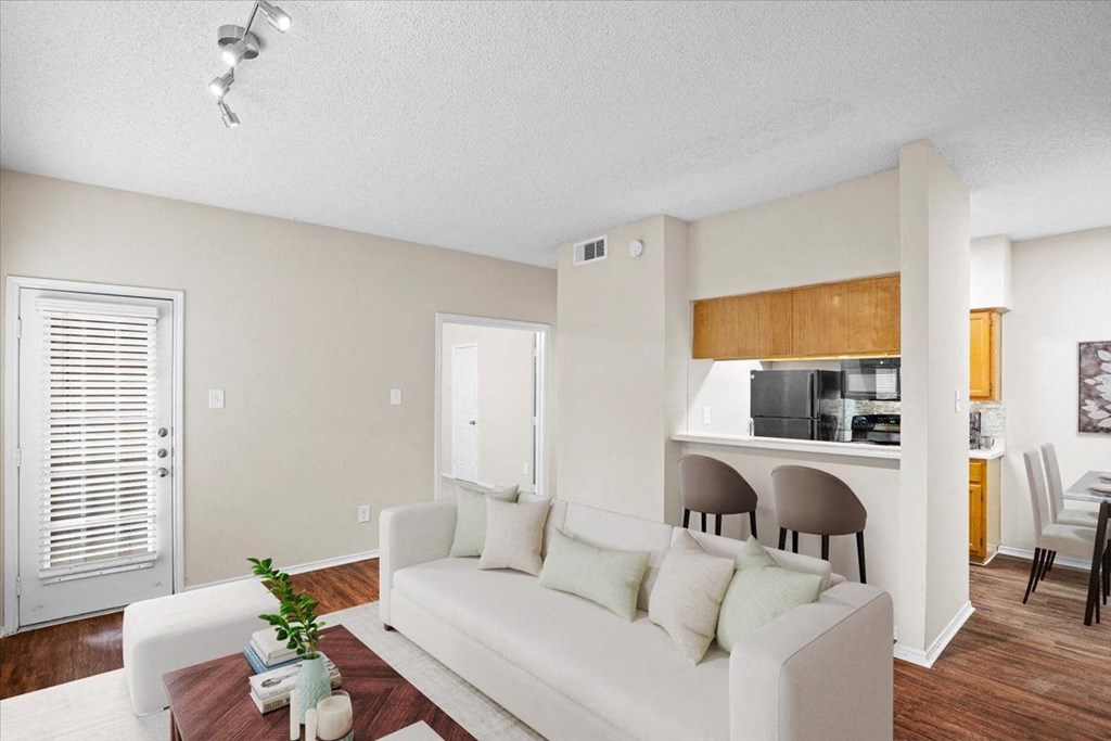 a living room with a couch and a coffee table at Creekview Apartment Homes, Dallas, Texas