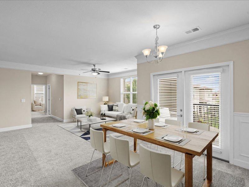 a dining room and living room with a table and chairs