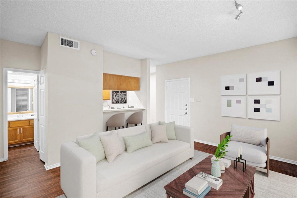 a living room with a couch and a coffee table at Creekview Apartment Homes, Texas, 75254