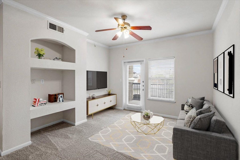 a living room with a ceiling fan and a window