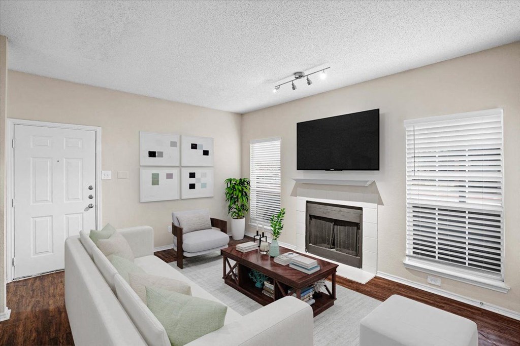 a living room with a fireplace and a tv above it at Creekview Apartment Homes, Dallas
