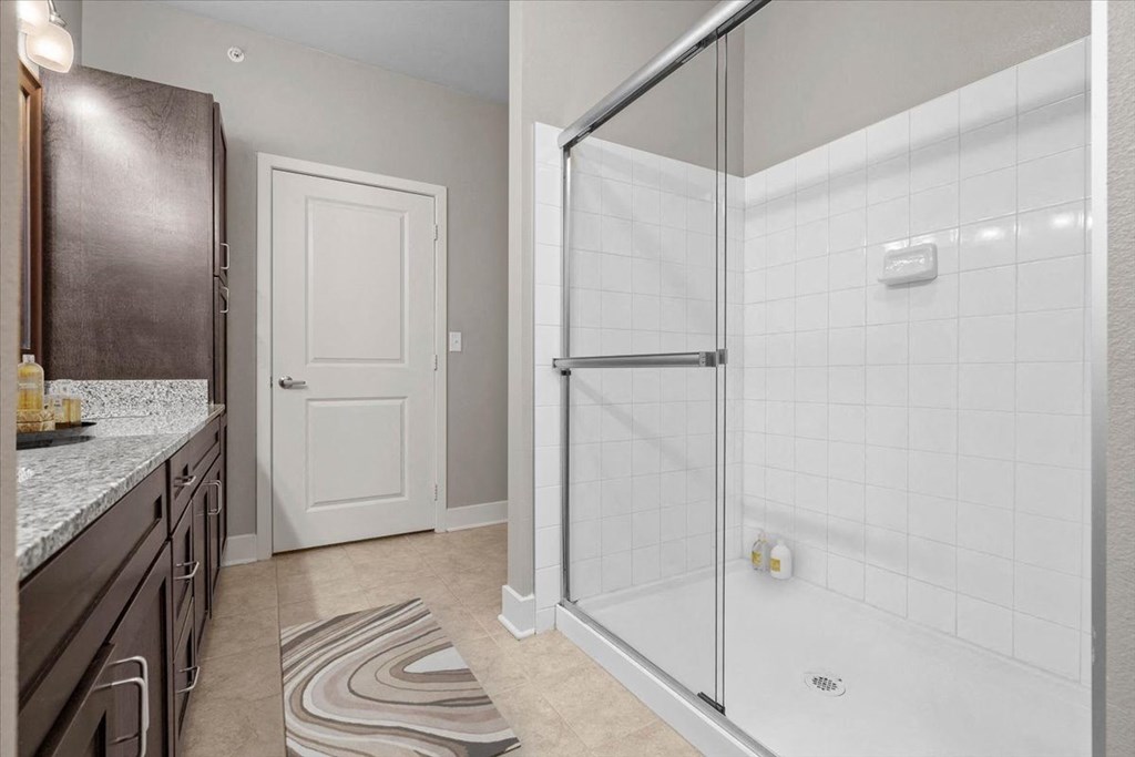 a bathroom with a shower and a sink