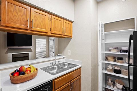 a kitchen with a sink and a refrigerator at Creekview Apartment Homes, Dallas, Texas