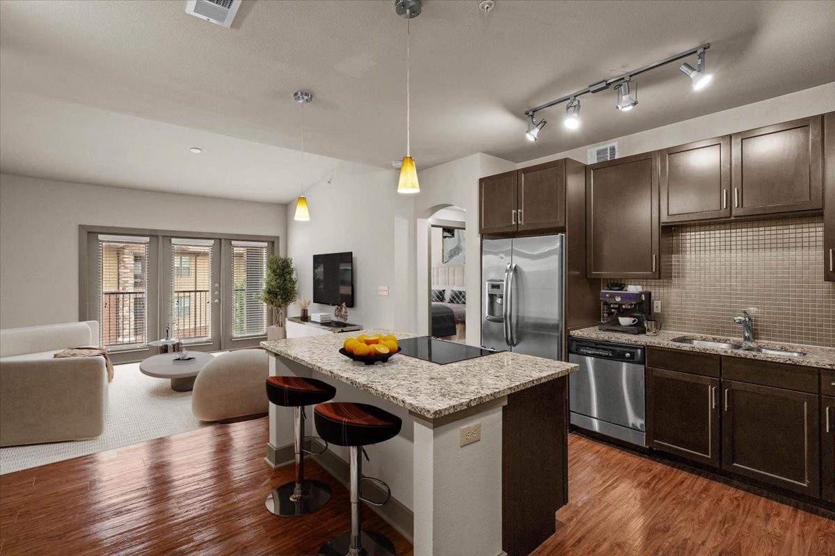 kitchen and living room at the district flats apartments in lenexa, ks