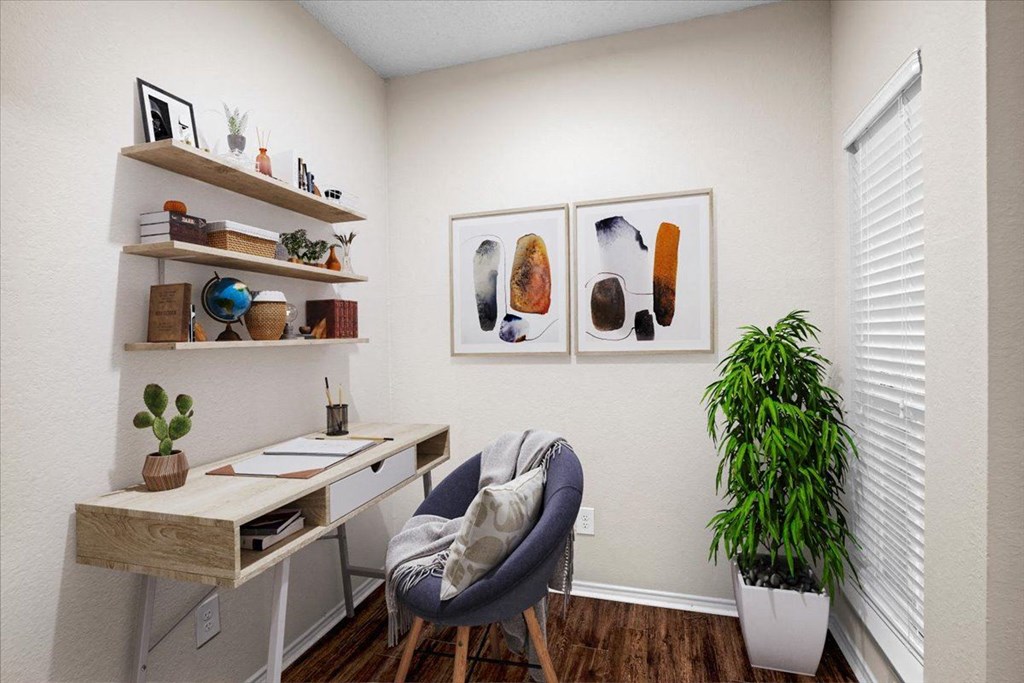 a home office with two paintings on the wall at Creekview Apartment Homes, Dallas