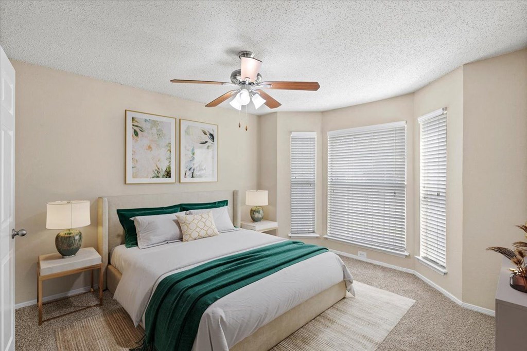 a bedroom with a large bed and a ceiling fan at Pear Ridge, Dallas, Texas