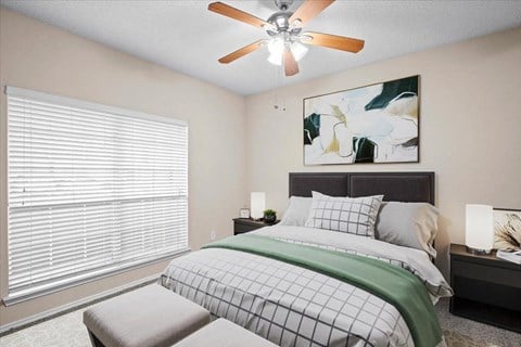 a bedroom with a large window and a ceiling fan at Creekview Apartment Homes, Dallas, TX