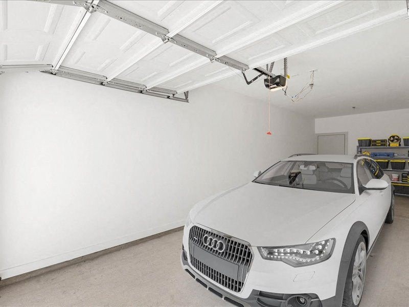 a car parked in a garage with a drone hovering over it