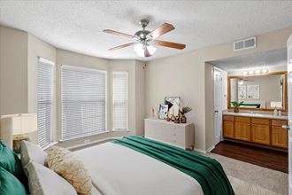 a bedroom with a large bed and a ceiling fan at Pear Ridge, Dallas