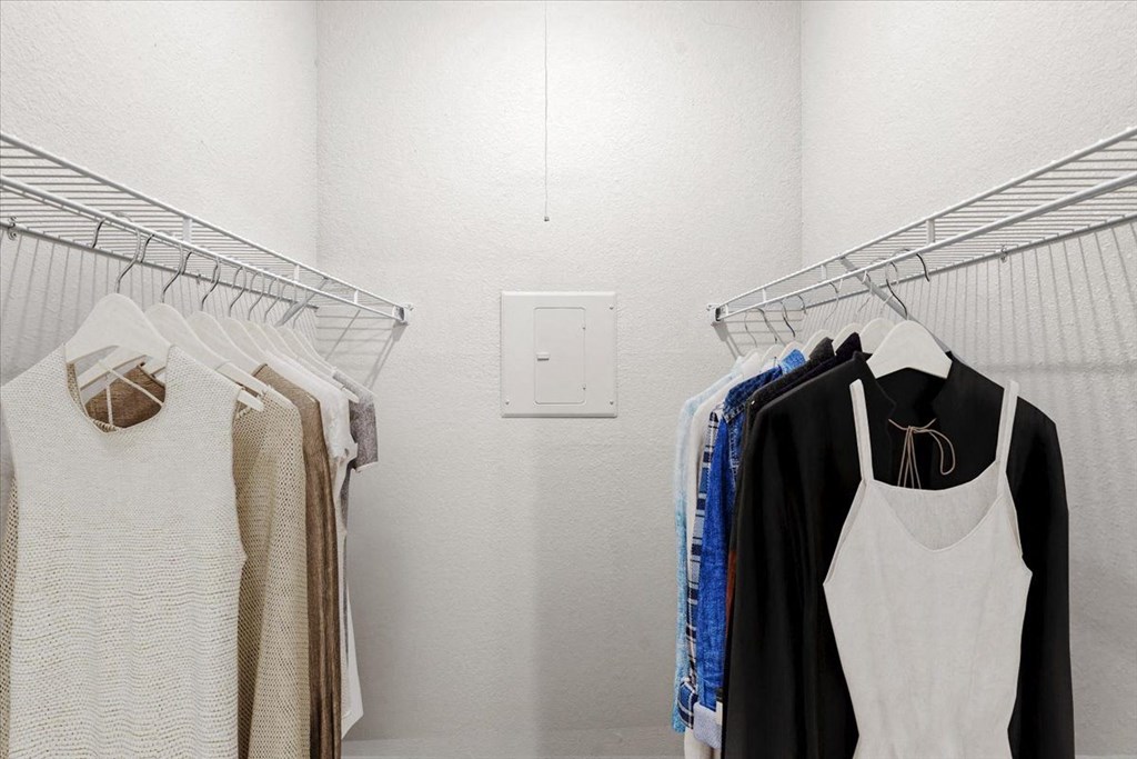 a small walk in closet with white walls and a white light switch on the wall at Creekview Apartment Homes, Dallas, TX