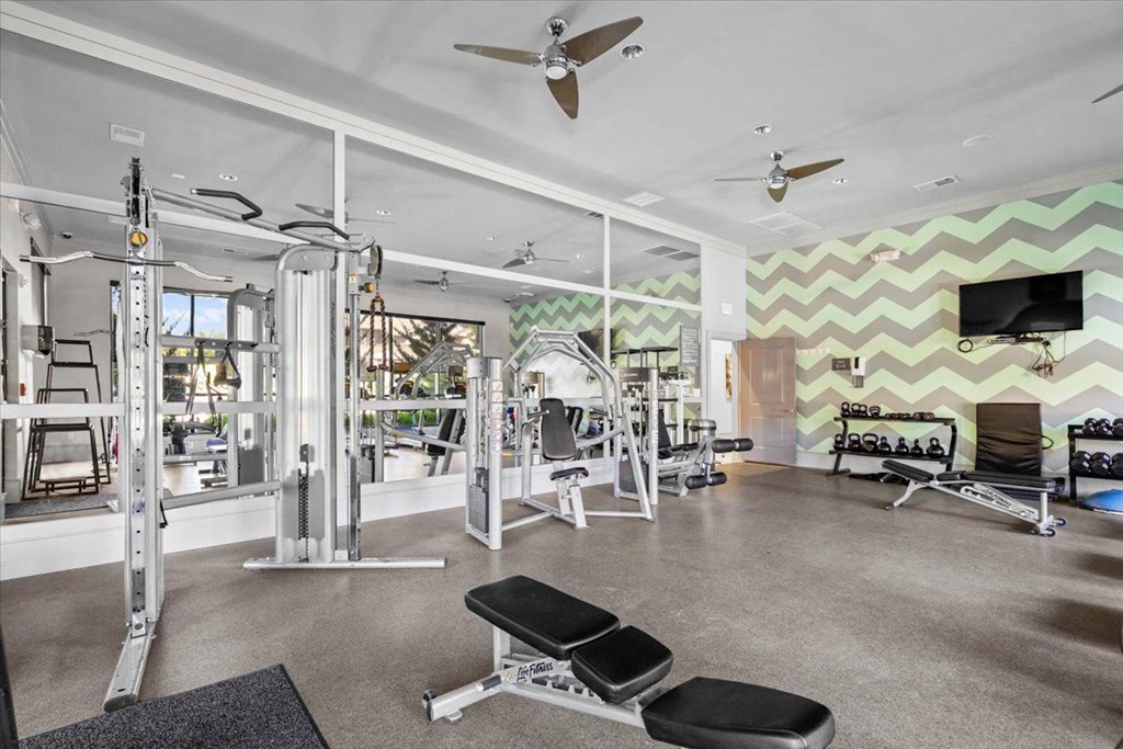 a home gym with a chevron wallpaper