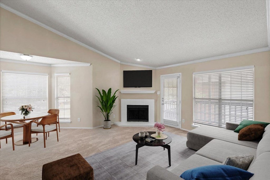 a living room with a fireplace and a tv above it at Pear Ridge, Dallas, TX