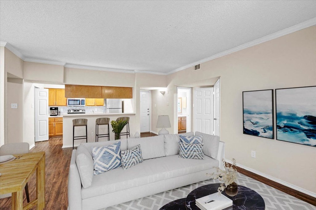 a living room with a couch and a table at Creekview Apartment Homes, Dallas, 75254