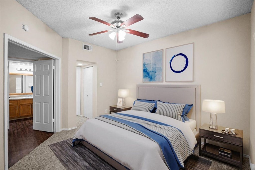 a bedroom with a bed and a ceiling fan at Creekview Apartment Homes, Texas
