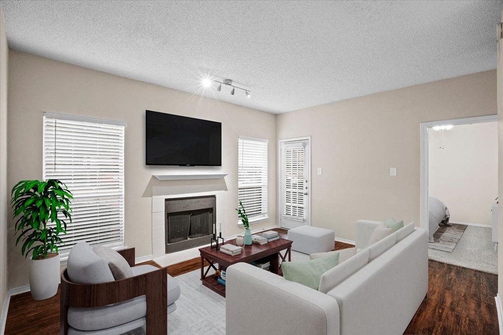 a living room with a fireplace and a tv at Creekview Apartment Homes, Dallas, 75254