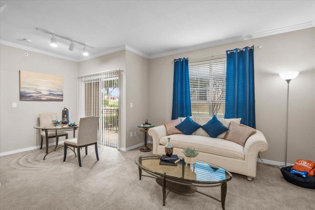 a living room with a couch and two chairs at The Clairborne Apartment Homes, Grand Prairie, TX, 75050