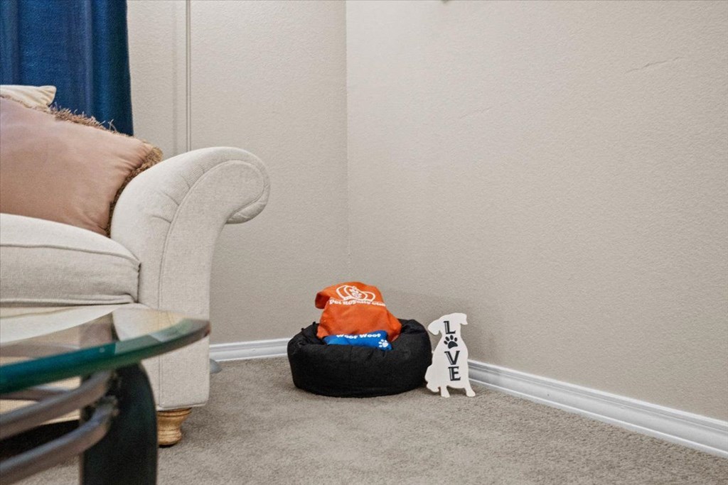 a living room filled with furniture and a white chair at The Clairborne Apartment Homes, Grand Prairie, Texas