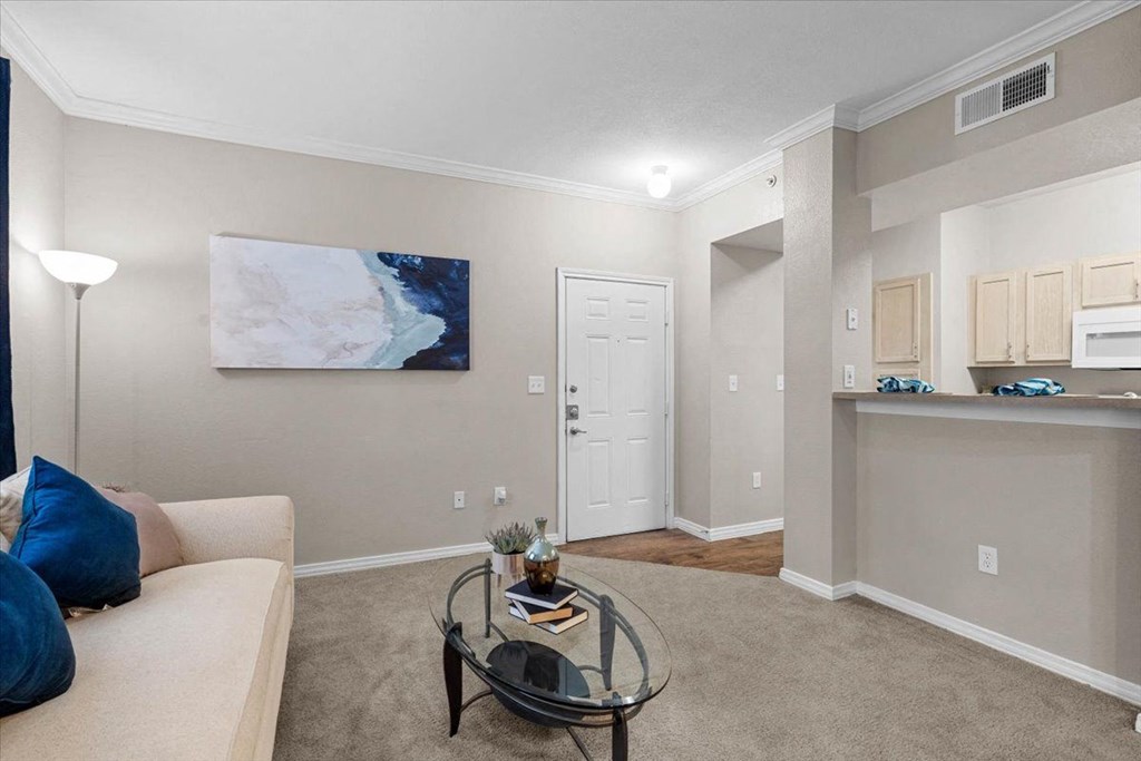 a living room with a couch and coffee table at The Clairborne Apartment Homes, Texas