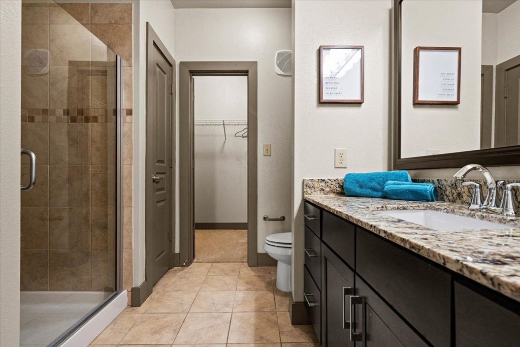 a bathroom with a shower toilet and sink at Cypress at Lewisville Apartment Homes, Lewisville, 75067