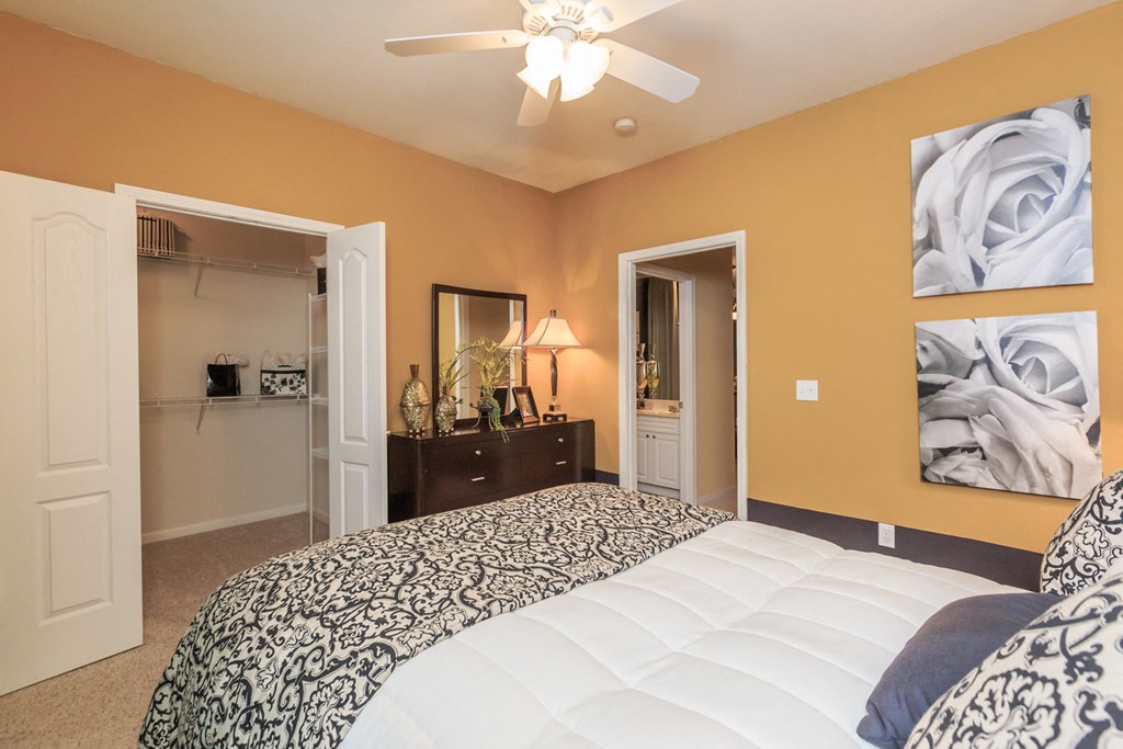 Bedroom with bed and attached closet and bath at Wynnewood Farms Apartments, Overland Park, KS, 66209