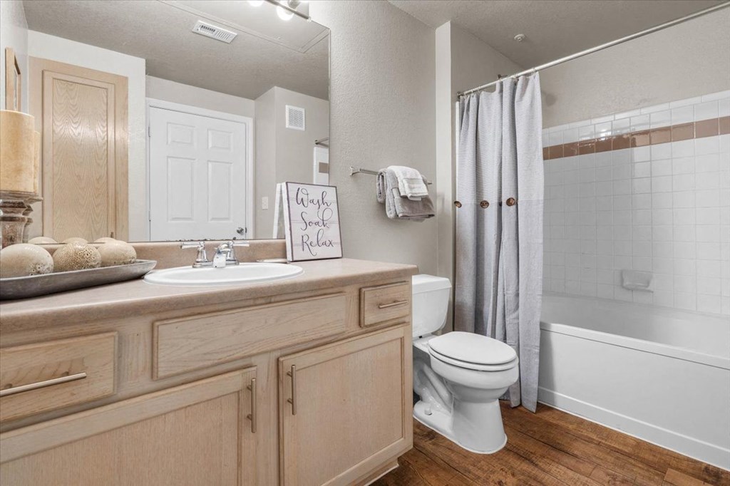 a bathroom with a sink toilet and shower at The Clairborne Apartment Homes, Grand Prairie, TX, 75050