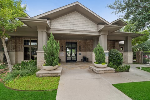A building with a front yard and a walkway leading to the entrance.